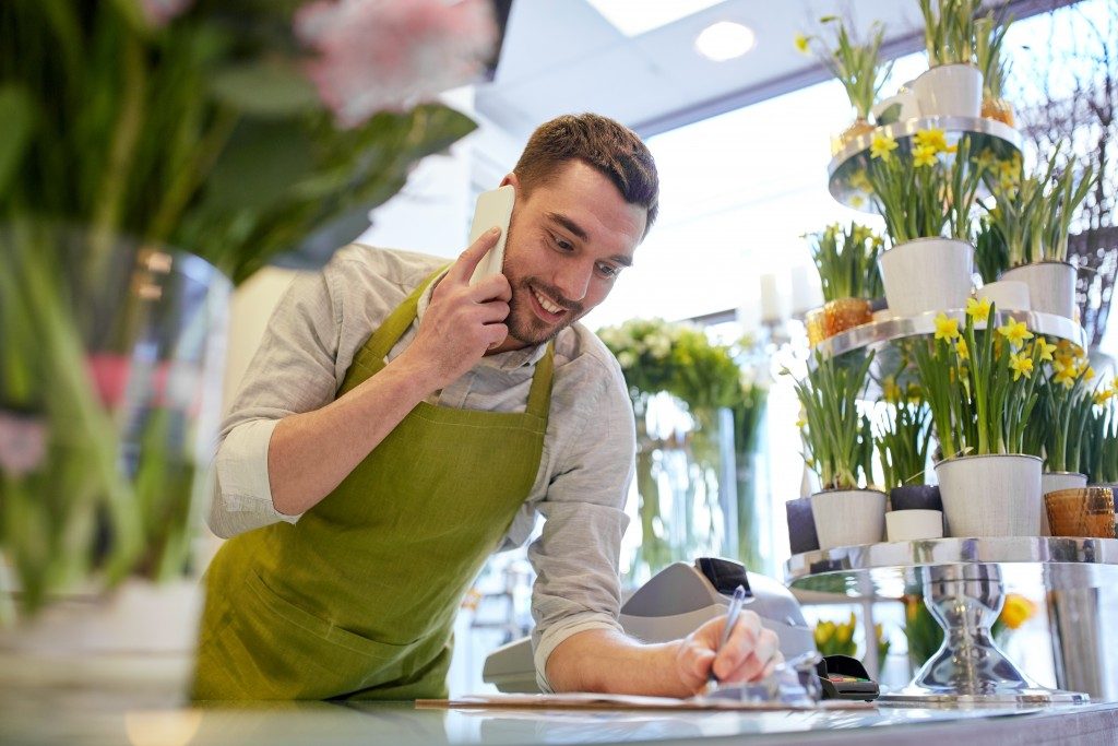 Guy at the flowershop taking orders